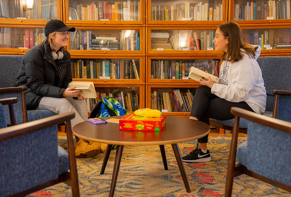A photo of two students with books