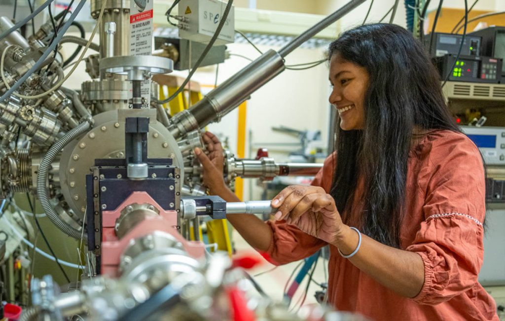 A photo of a woman working at a machine