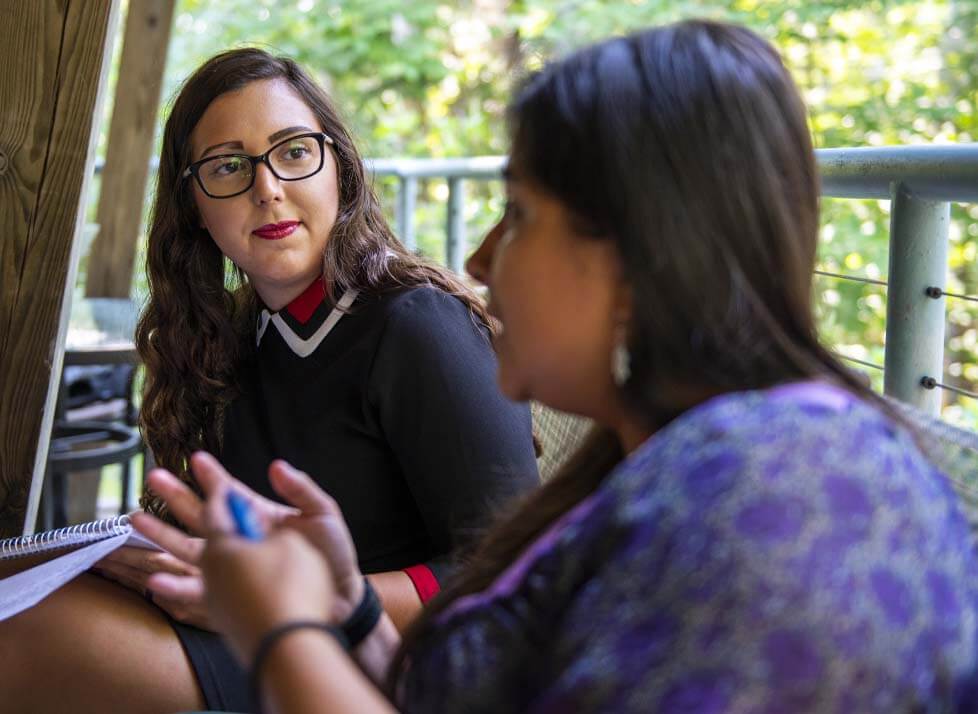 A photo of two people talking
