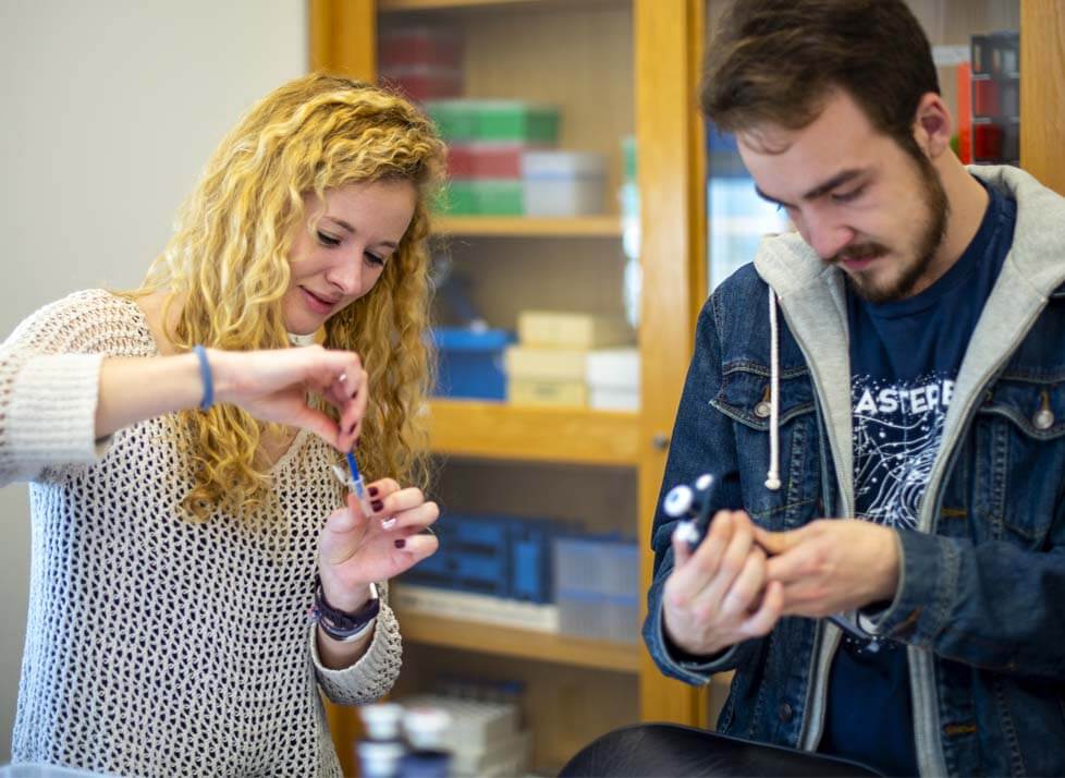 A photo of two students in a lab