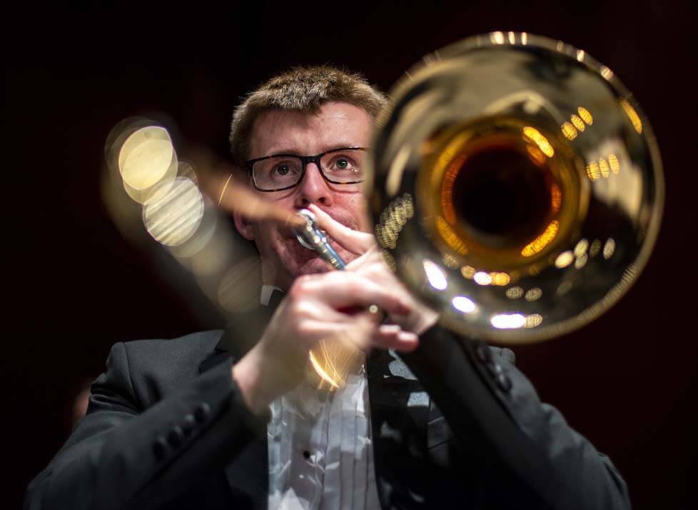 A photo of a music student playing a trombone