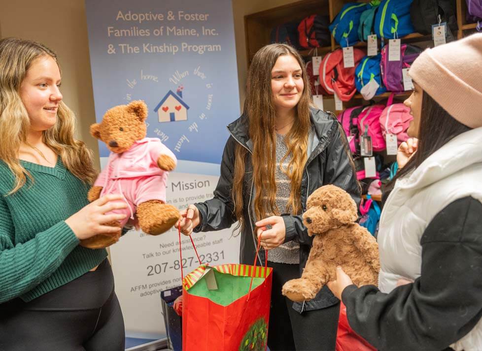 A photo of three social work students gathering items for donation