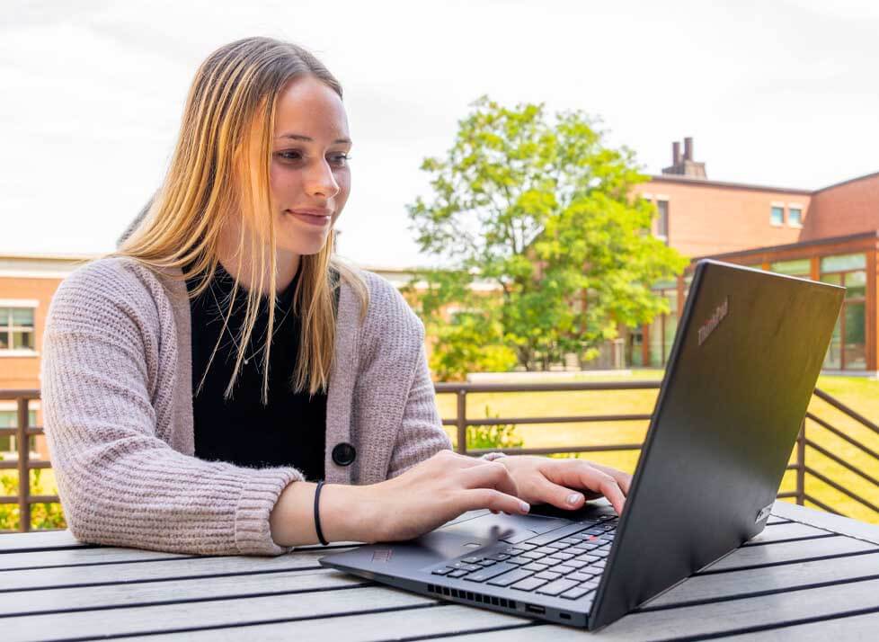 A photo of a person working at a laptop
