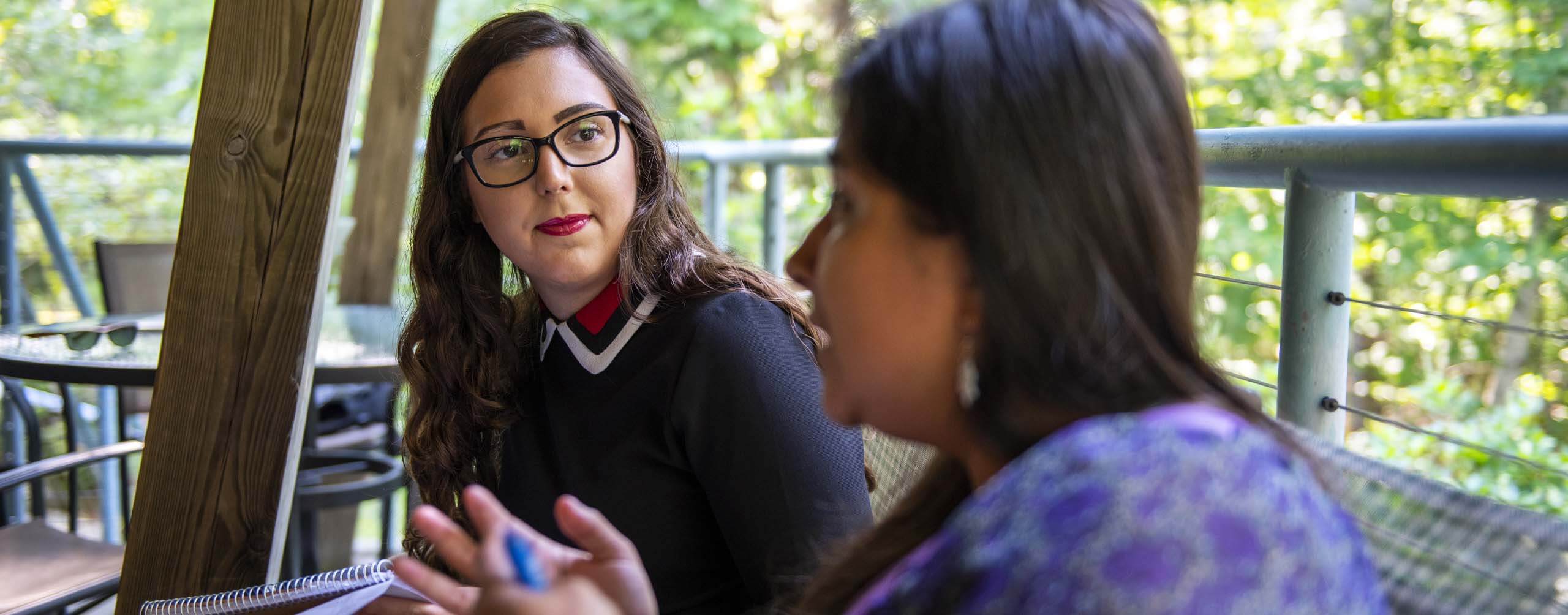 A photo of two people talking