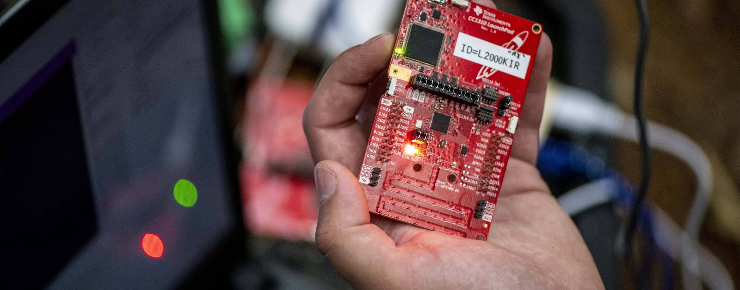 A photo of a hand holding a computer component