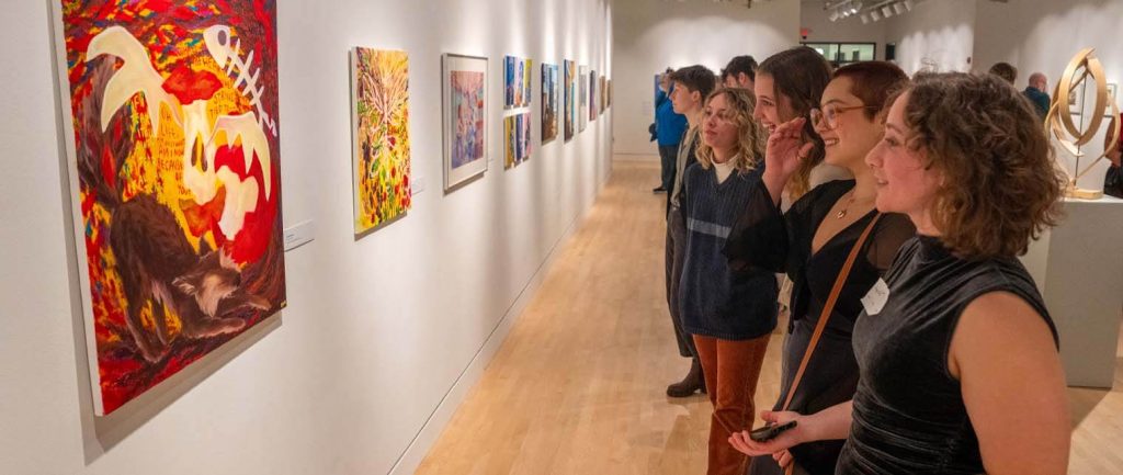 A photo of people looking at artwork in Lord Hall Gallery