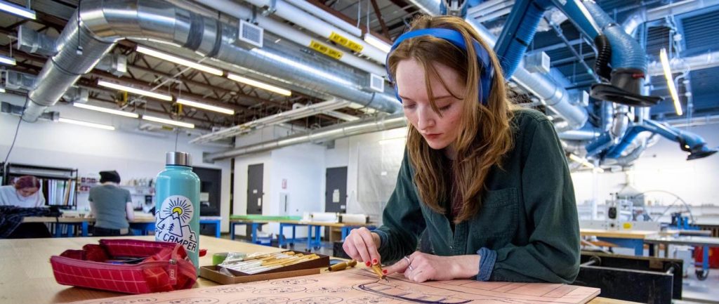 A photo of an art student in a print making class